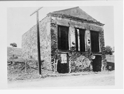 A photograph of the remains of an abandoned general store.