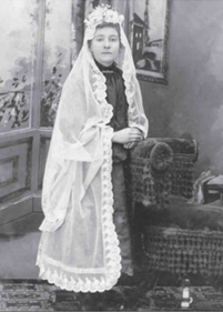 A photograph of a young girl in a Communion Dress (ca. late 1880s).