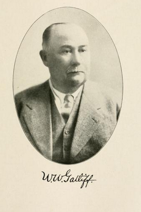 A photographic portrait of a well-dressed man.