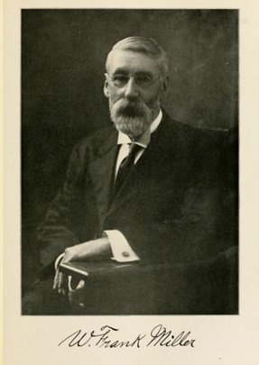 A photographic portrait of a man seated in formal attire.