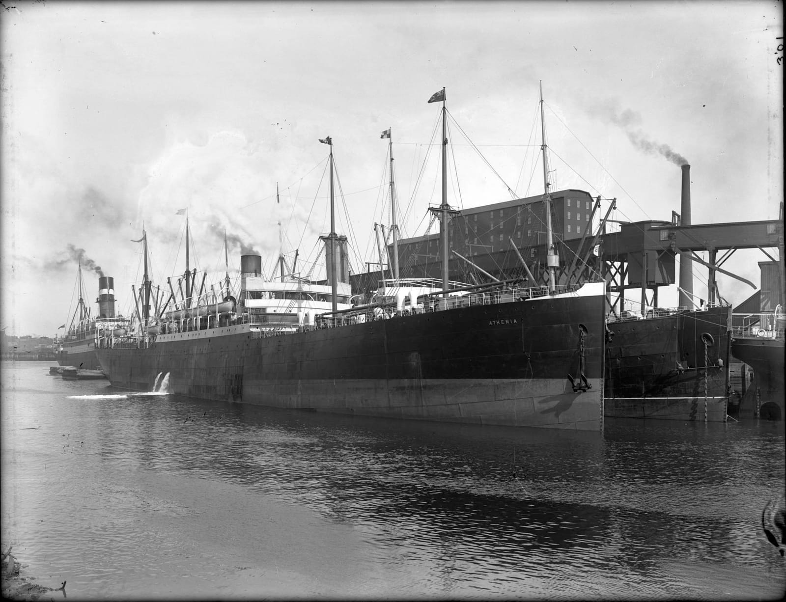 A photograph of a steamship docked in port.