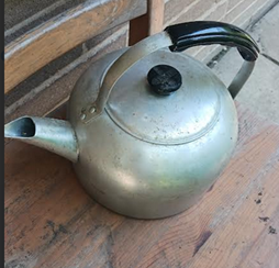 A photograph of an old Wear-Ever brand kettle.